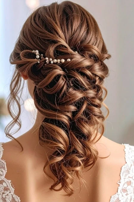 A detailed view of a glamorous prom hairstyle featuring voluminous curls and pearl hair accessories, perfect for a special night out. This hairstyle complements formal dresses and enhances your overal.