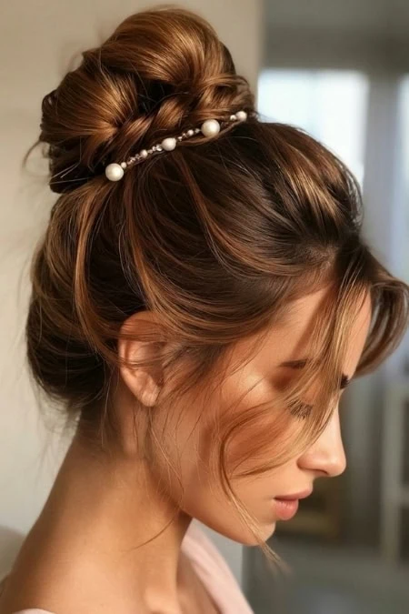 Elegant bridal hairstyle featuring a sophisticated updo adorned with pearl hair accessories, perfect for weddings and special occasions.
