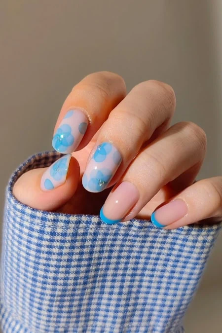 Beautiful close-up of a hand with light blue nails for spring or summer.