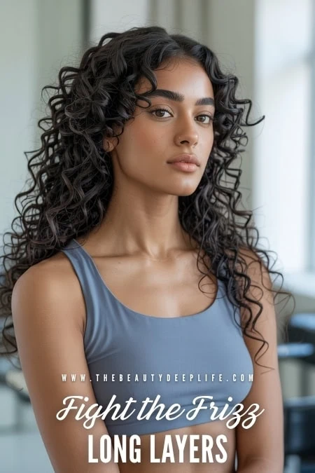 Woman with long, curly hair showcasing frizz control and layered hairstyle, promoting hair care solutions for frizz-free, healthy curls.