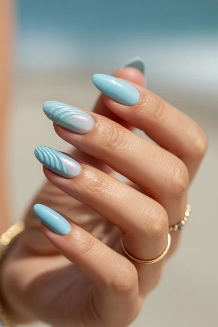 Beautiful close-up of a hand with pastel blue and white marbled nail polish, highlighting detailed nail art design and well-groomed nails, ideal for beauty and fashion content.