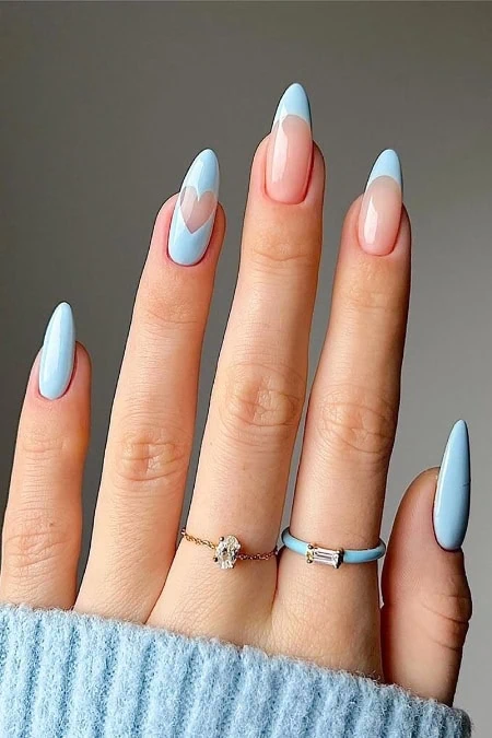 Stylish light blue and nude nails with rings, perfect for beauty and fashion enthusiasts.