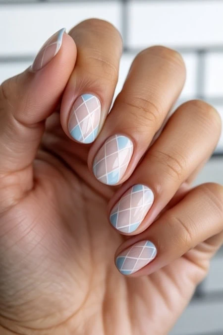 Elegant geometric nail art with pastel blue and white patterns on well-manicured nails, showcasing a modern and stylish look. Perfect for beauty, nail art, and fashion enthusiasts.