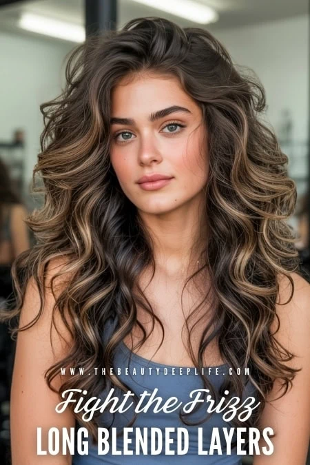 Beautiful young woman with voluminous, long, curly hair featuring blended layers, showcasing healthy hair styling and hair care tips for natural curls.