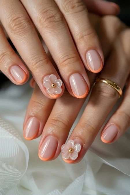 Elegant manicure and delicate 3D florals showcasing a sophisticated and feminine beauty style.