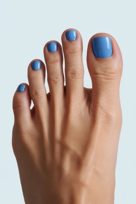 Beautiful blue painted toenails and fingernails showcasing a professional pedicure and manicure for a polished look. Perfect for beauty, self-care, and nail art enthusiasts.