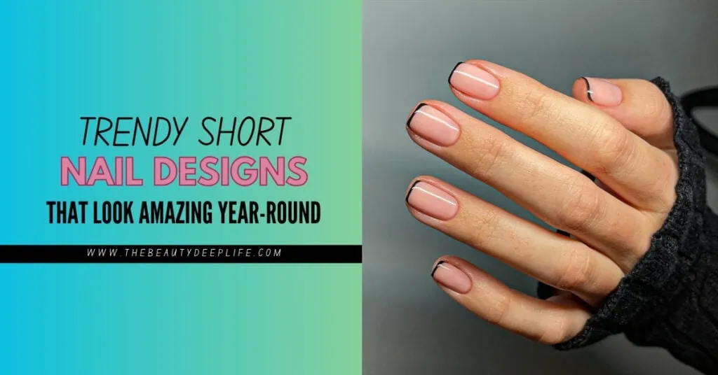 Close-up of a hand with trendy short nail designs featuring a nude base and black tips, showcasing stylish nail art for a modern look.