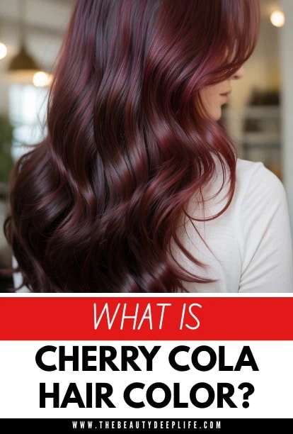 Close-up of a woman with long, wavy cherry cola hair color, showcasing rich, vibrant reddish-brown tones with soft waves, in a salon setting.
