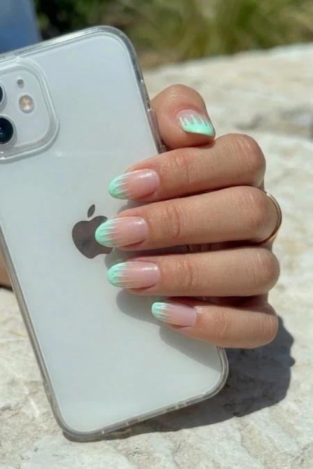 Close-up of a hand with mint manicure tips