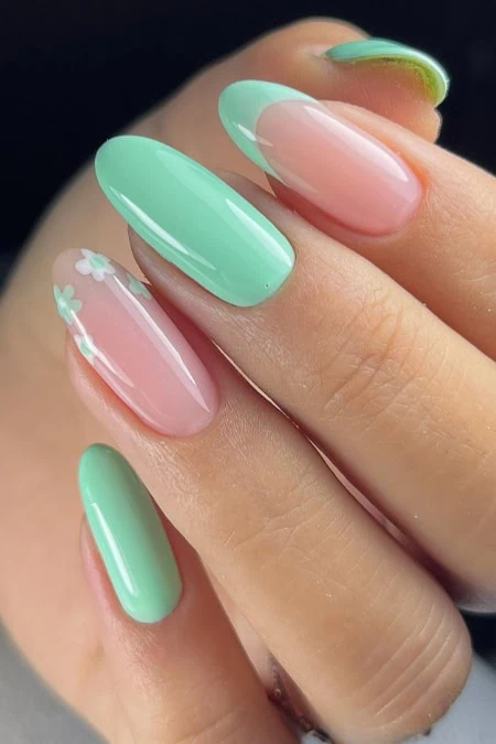 Elegant green and pink nail design with floral accents, perfect for all year round, showcasing trendy nail art from The Beauty Deep Life.