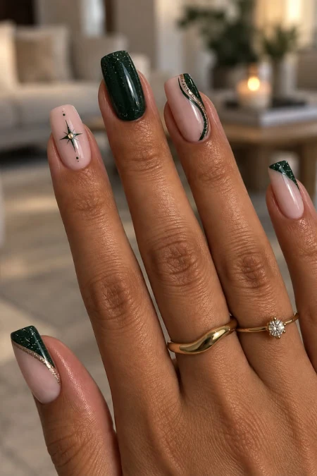 Elegant manicured winter nails with dark green, pink, and glitter accents, featuring star and stripe designs, showcased on a woman's hand with rings in a cozy, well-lit living room.