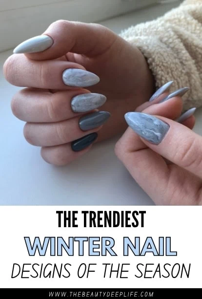 Trendy winter nail designs featuring marble and matte finishes in shades of blue and gray, perfect for the season, showcased on well-manicured nails.