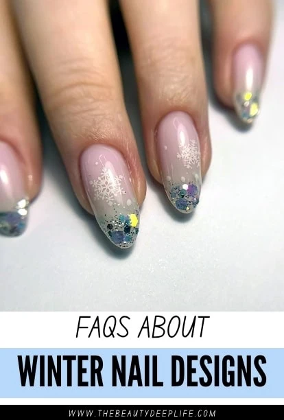 Close-up of winter-themed nail art with snowflake designs and glitter on natural nails, perfect for seasonal nail art inspiration.
